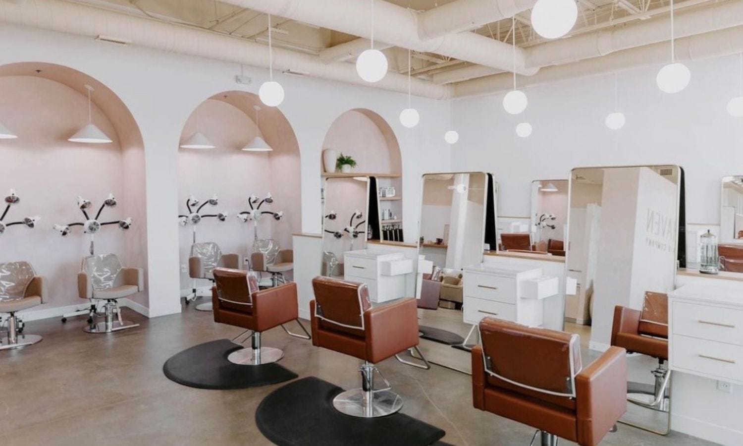 large hair salon with six styling stations and four color processing stations