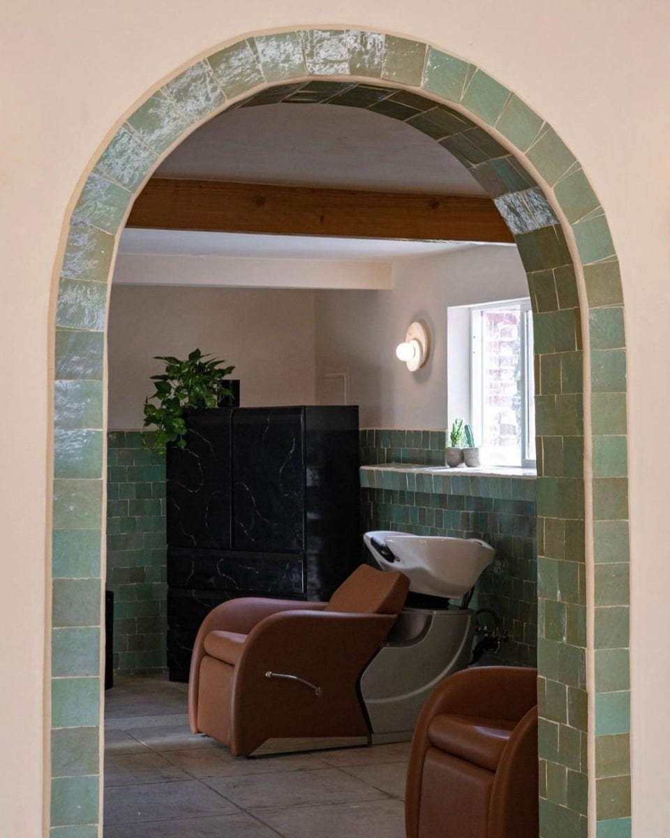 two reclining shampoo systems in a tiled shampoo area in a luxury salon