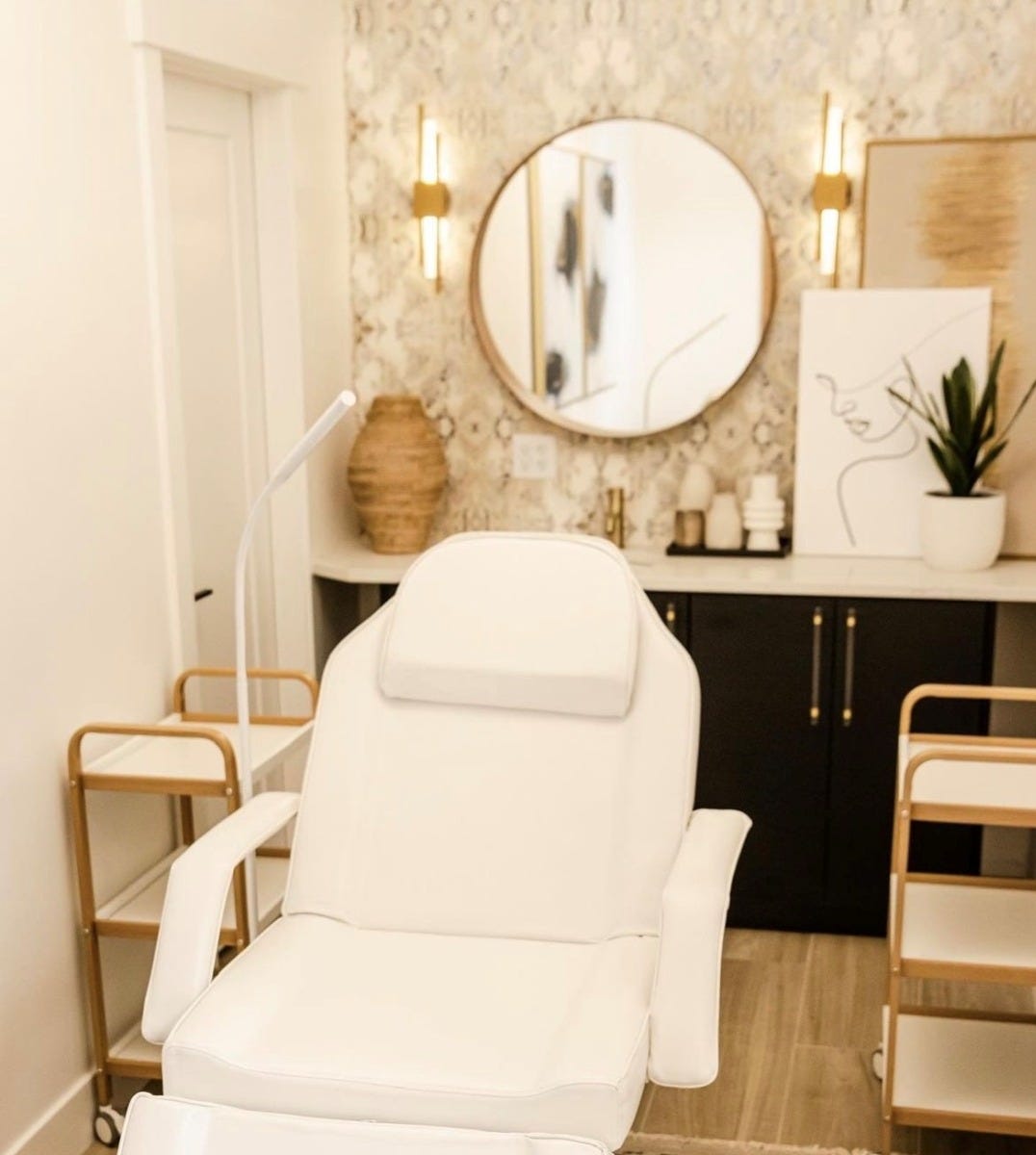 opening a med spa treatment room with white facial chair, rolling carts and LED lamp